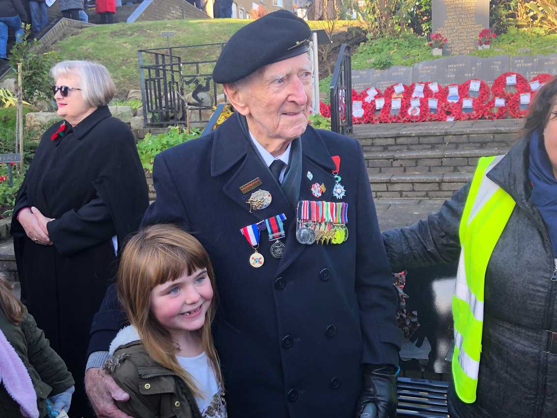 A veteran poses with a local girl at the Veteran's Day ceremony on the Isle of Man.