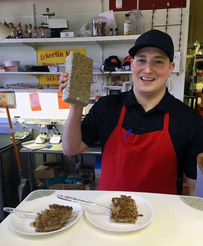 Josh Lillis, one of a long line of family owners of Eckerlin Meats, offers a taste of goetta to visitors on Cincinnati Food Tours. 