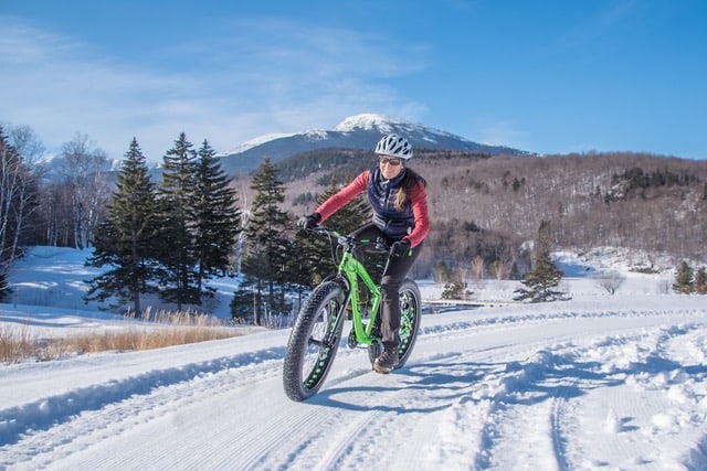 Fat tire biker near Attitash Ski Resort in New Hampshire's White Mountains. Wiseguy Creative photo.