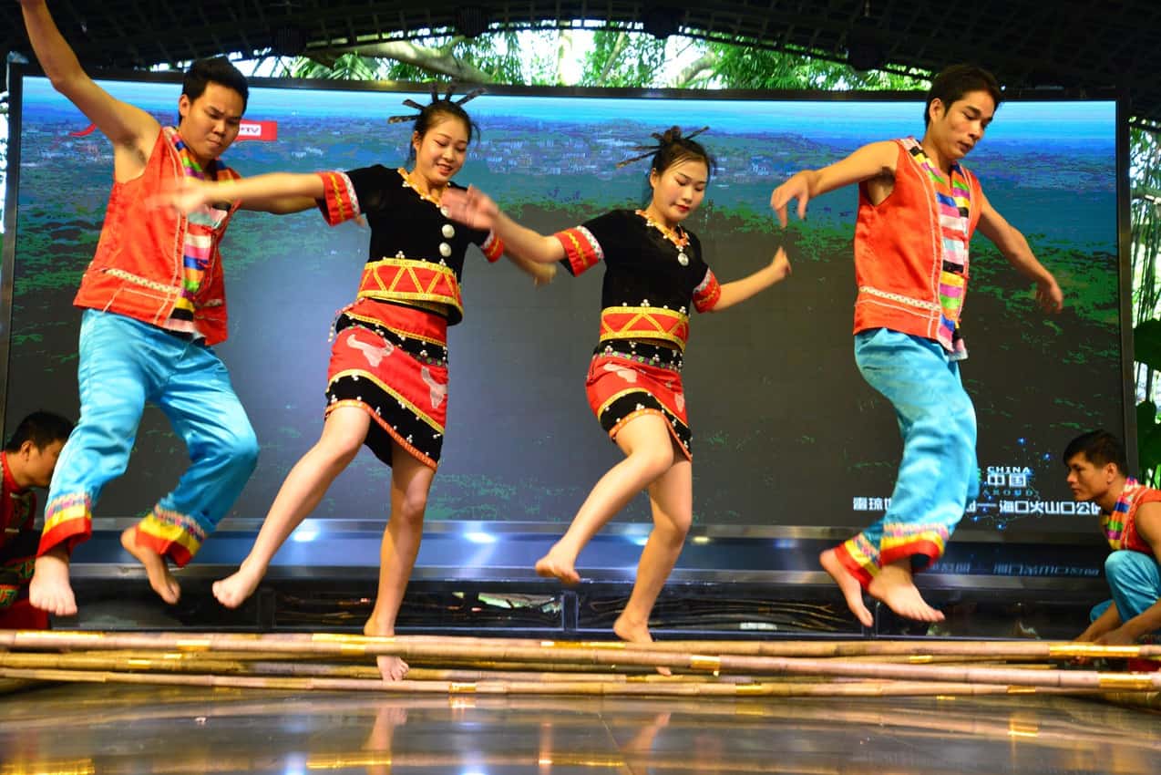 Li people, the earliest inhabitants of Hainan, perform a traditional bamboo dance that encourages friendship.