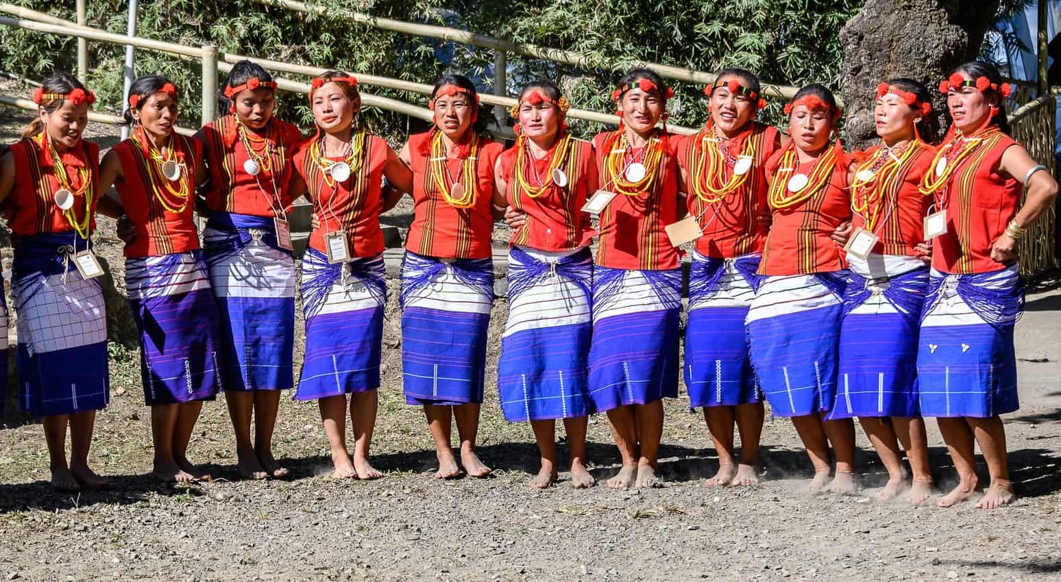 Tribal women dancing barefoot lock arms as they move in a counterclockwise circle during a demonstration at the Hornbill Festival in Nagaland, India. Donnie Sexton photos.