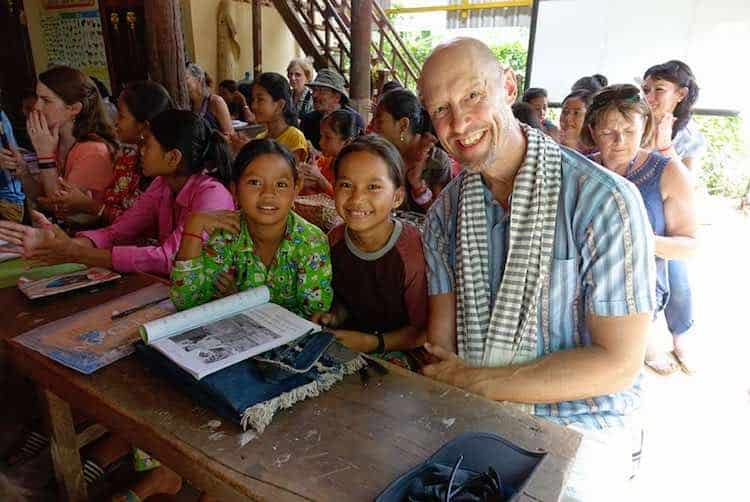 In Cambodia, visiting a one-room schoolhouse. John says he will go back to this beautiful country again and again. The people are so special.