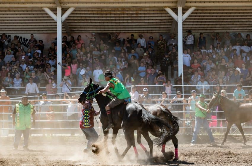 The wild and wooly Indian Relay teams consist of three horses, one rider, one mugger or catcher, and two holders.