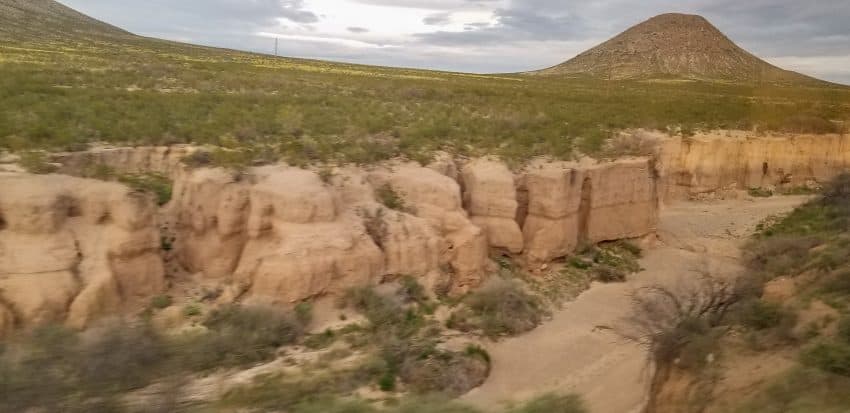 Rugged landscape of the south passing by the train window.
