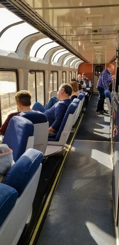 People gathered in the Observation Car on an Amtrak train