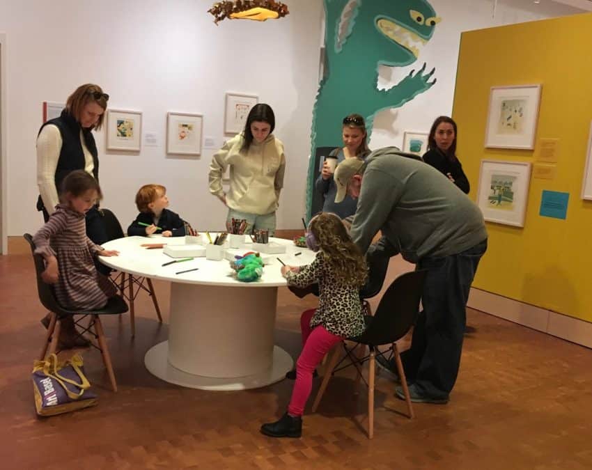 Budding illustrators gather round a table at the Eric Carle Museum of Picture Book Art.