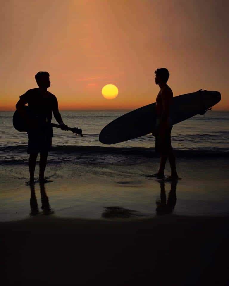 A guitarist and a surfer on the beach in Jericoacoara, Brazil. Johnny Motley photos.