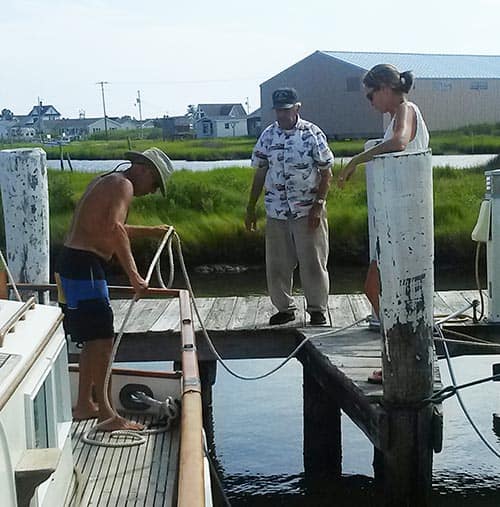 Tourist Boat Captain tying up at Parks Marina, with Milton Parks on Tangier Island.