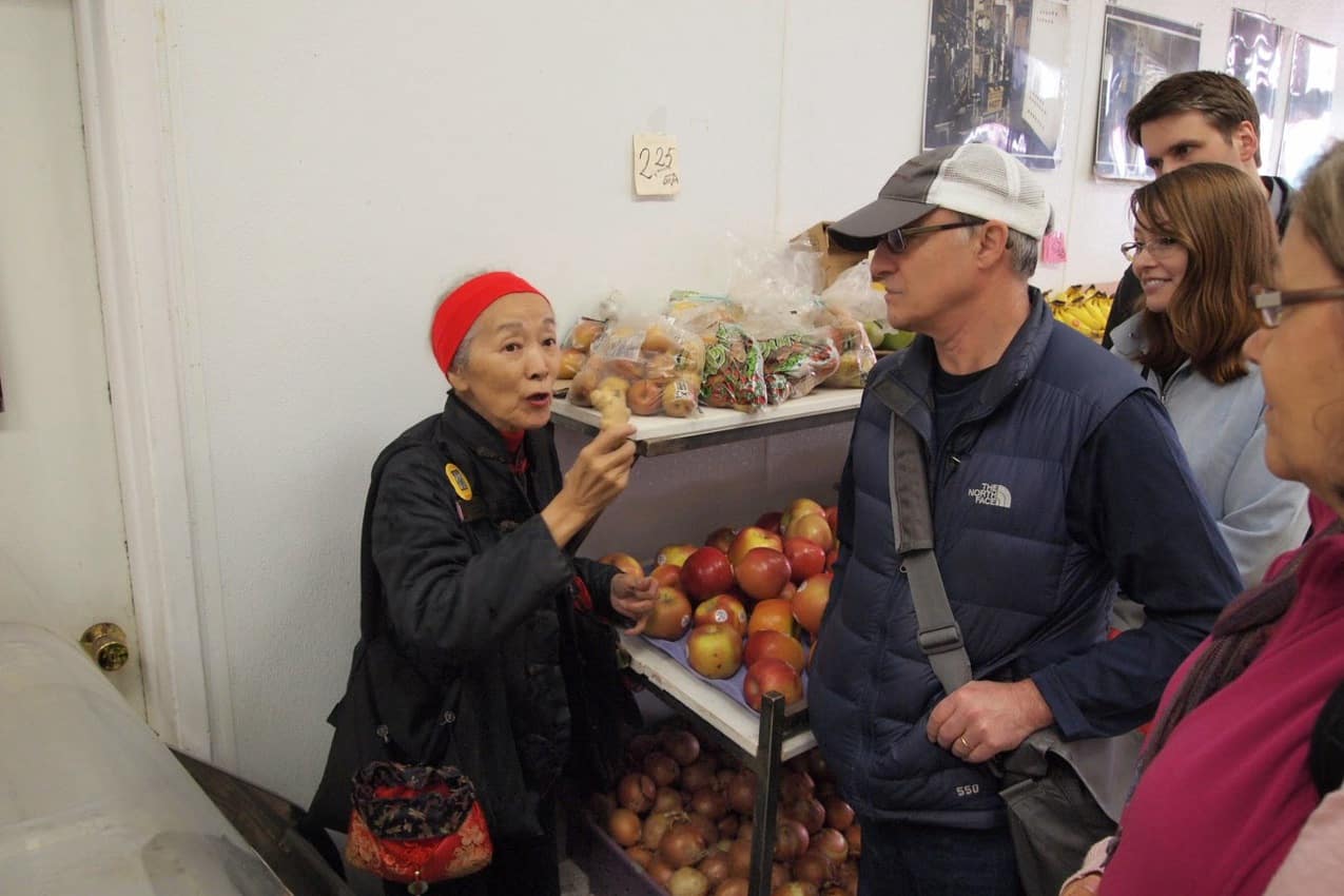 Dorothy explains the many healing properties of ginger at a local market in Chinatown.
