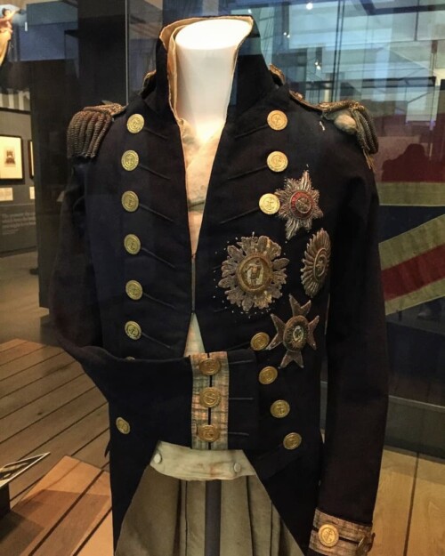 The uniform Nelson was wearing when he was shot and killed at the battle of Trafalgar. You can see the bullet hole by his left shoulder. The bullet, fired from above by a French sniper, went down and penetrated Nelson's spine.