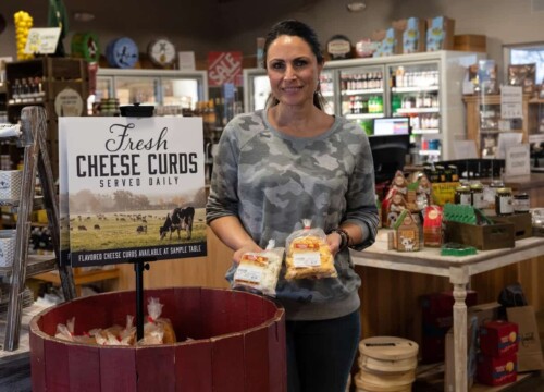 Franca Bueno holds bags of Renard's signature hand-crafted cheese curds in Sturgeon Bay Wisconsin.