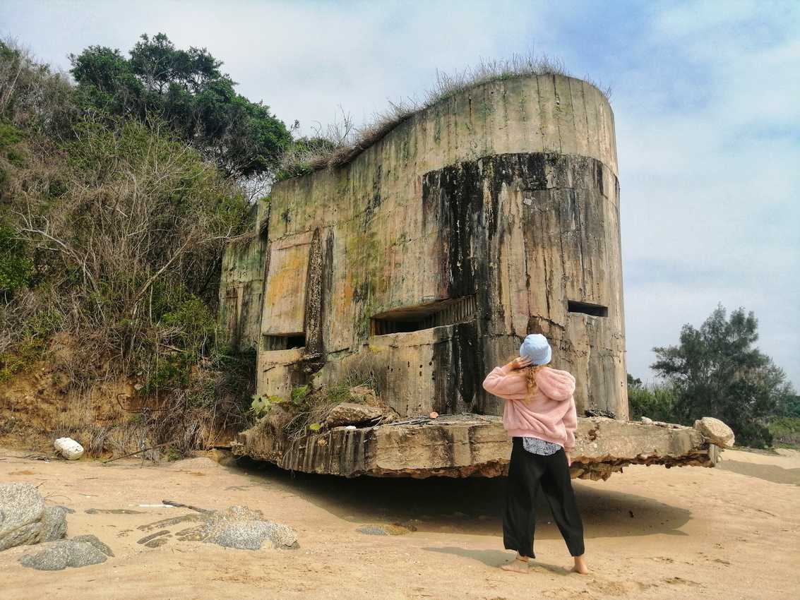 A machine gun bunker sticks out from Kinmen Island's granite hills onto the beach