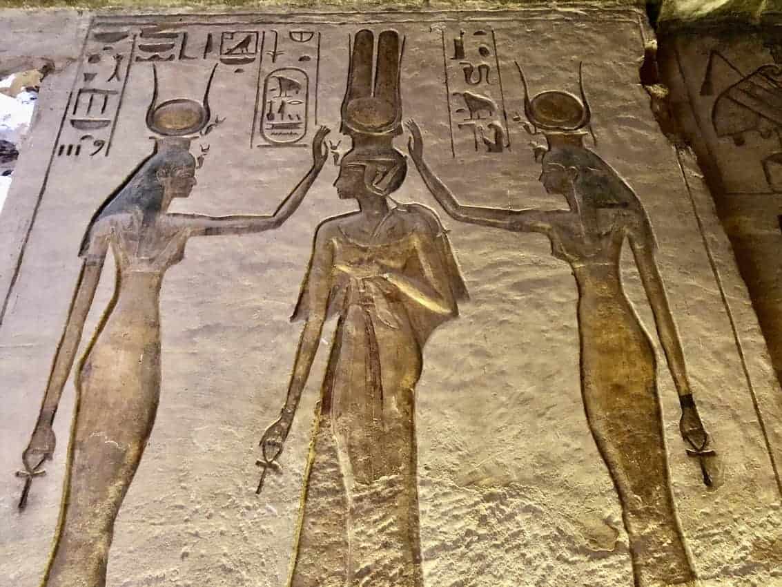 Goddess Isis and Goddess Hathor are blessing Queen Nefertari, while each have an Ankh, the symbol of life in their hand. 