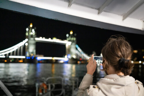 Woman capturing the view. Uber Boat by Thames Clipper Photos.