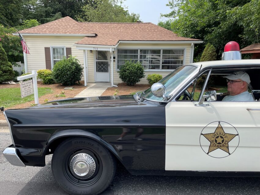 Squad car driver Steve Talley in front of Andy Griffith's boyhood home. You can rent the entire house (which has all 249 episodes) from the Hampton Inn Mount Airy.