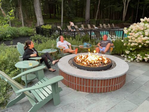 Guests enjoying the outdoor firepit near the pool at the Inn.