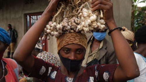 A woman selling garlic at Musanze Market