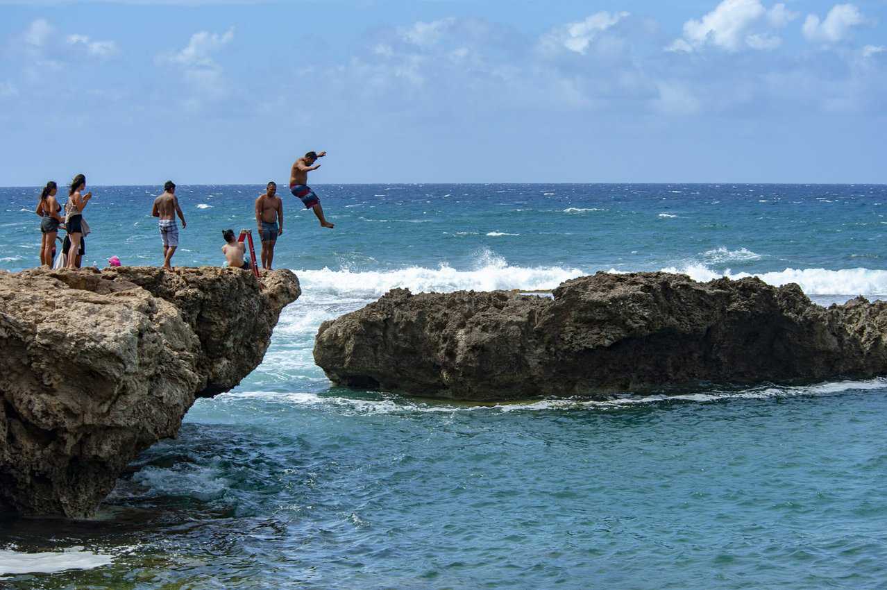Where the shoreline created a natural barrier from ocean swells safe enough for swimming, some locals took the opportunity to enjoy a bit of cliff jumping.