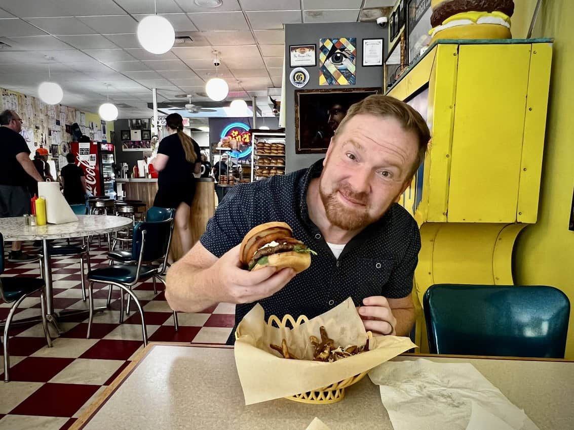 John Martin, a resident of Billings, readies to bite into a burger at The Burger Dive in Billings.