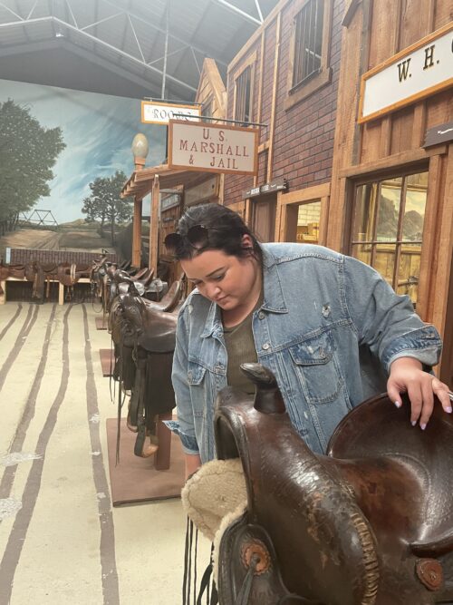 Nicole Gonzalez checks out one of many old saddles on display at Range Riders Museum in Miles City.