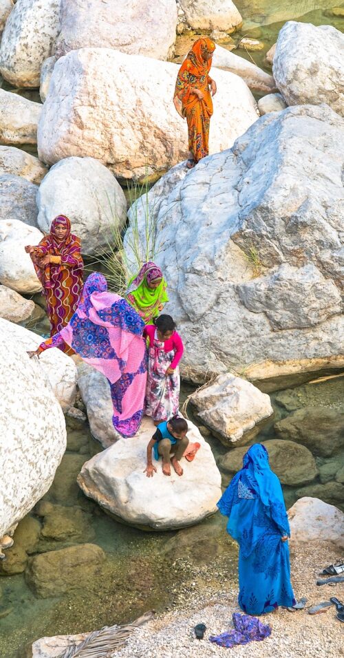 Omani women shun the black abayas of their sisters in neighbouring countries in favour of colourful abayas. Wadi Tiwi, Oman.