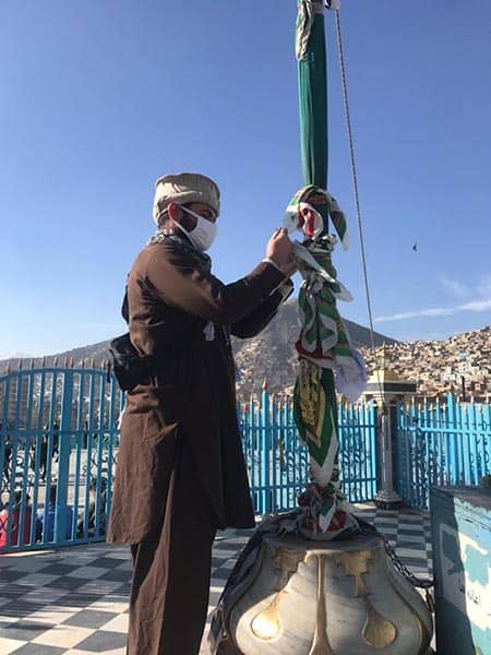 TYING THE FLAG- An incredible experience at the Sakhti Shrine in Kabul. Note the discrete local clothing.
