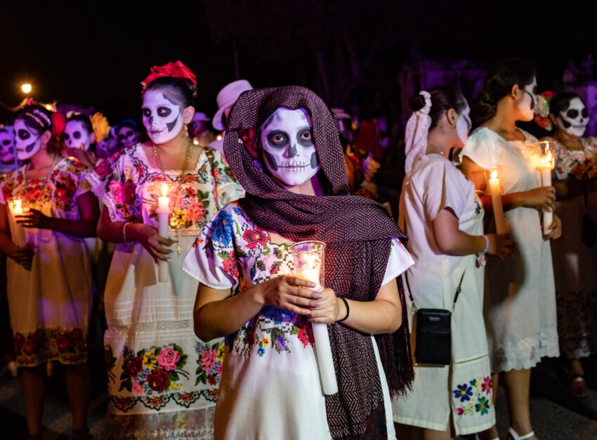 For the Parade of Souls, women and girls with faces made up to resemble skeletons, wore traditional Yucatan white dresses embellished with colorful embroidery.