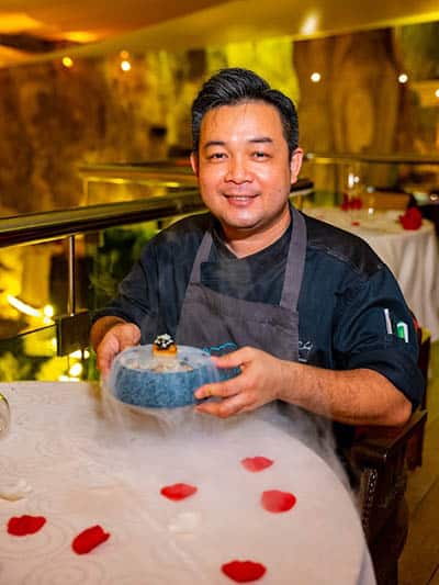 Chef Boon with a smoking dish