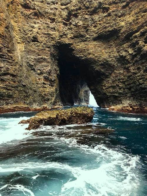 Passing some of the Na Pali Coast's smaller caves- © Michael Kompanik