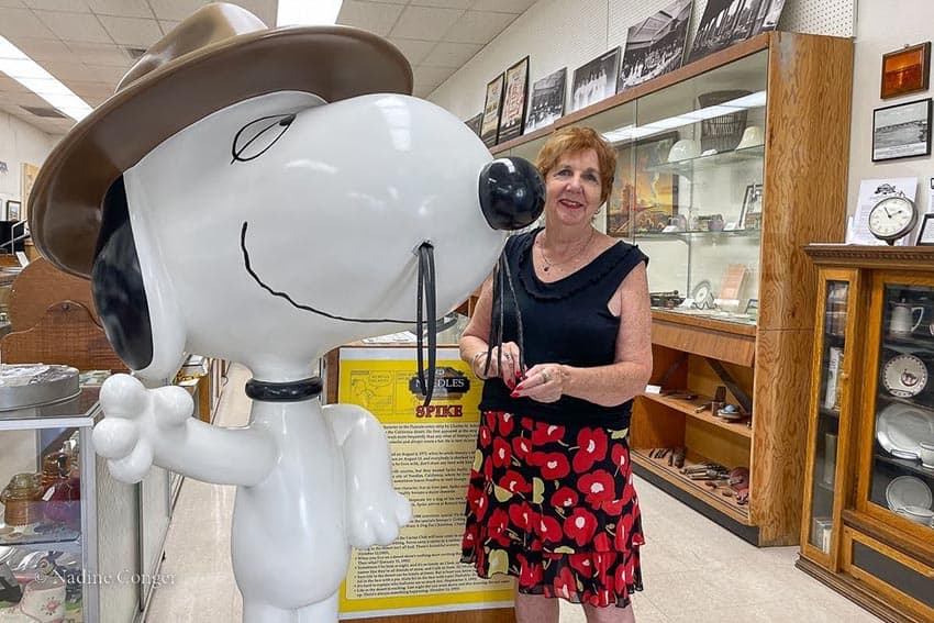 Kathy Condon stands with Spike, Snoopy's brother. Charles Schultz had a dog named Spike when he lived in Needles. Photo by Nadine Conger