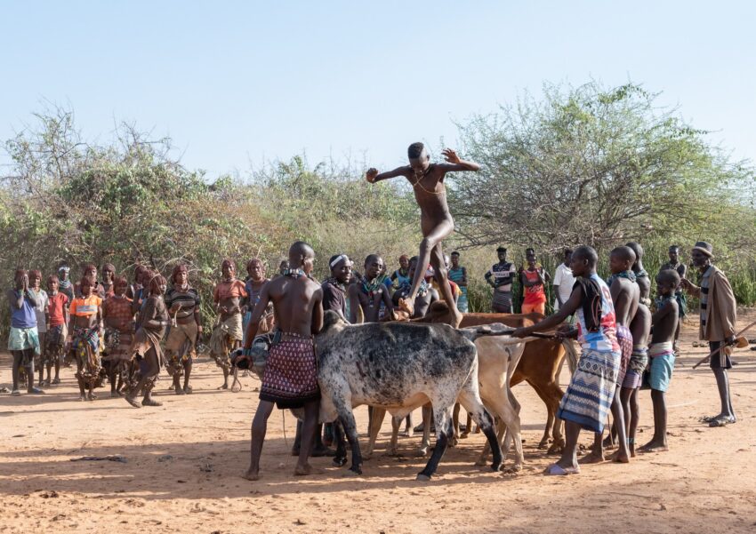 A Hamar woman being whipped by a man at a Jumping of the Bull