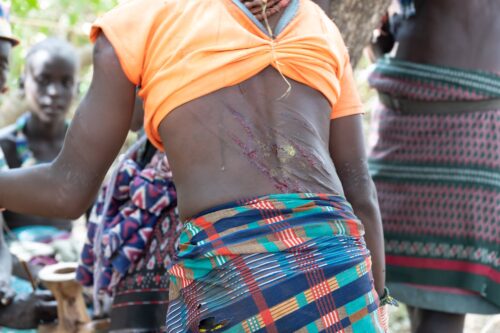 This Hamar woman proudly wear the scars from being whipped, evidence of what she has sacrificed for her tribe.
