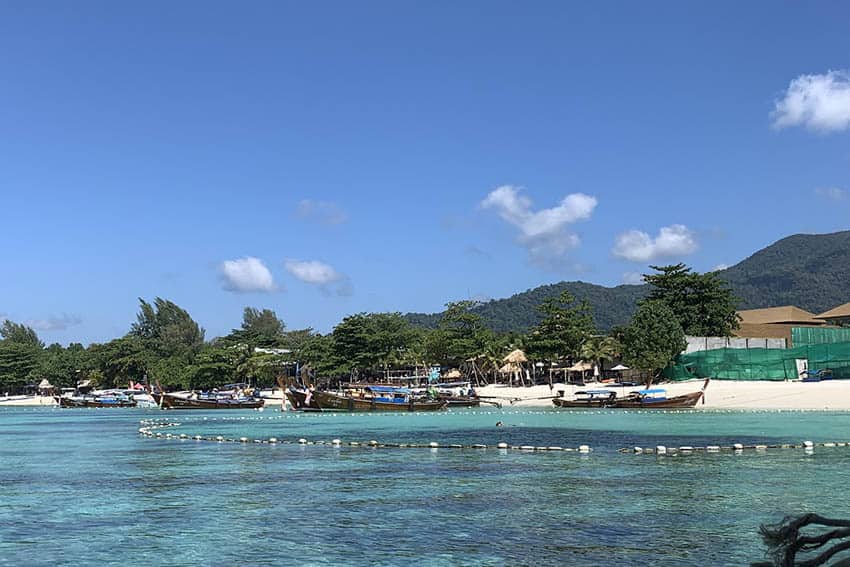 The crystal-clear waters and powdery sand of Pattaya Beach as seen from coming onshore on a longtail boat.