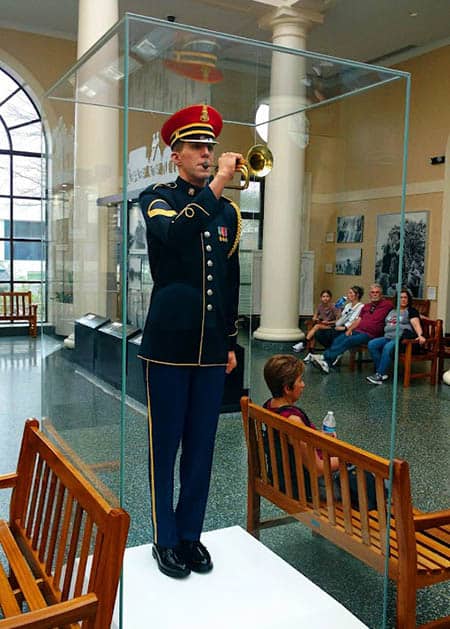 Playing Taps. The Welcome Center provides a history of Arlington National Cemetery.