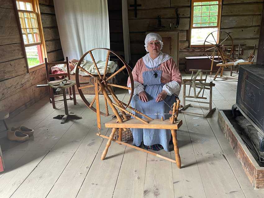A local woman dressed like an Acadian at the Acadian Village in Bertrand New Brunswick, where 42 period houses can be explored.