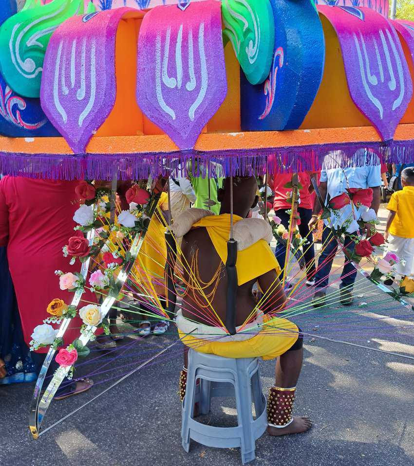 A kavadi bearer taking a rest before continuing the procession