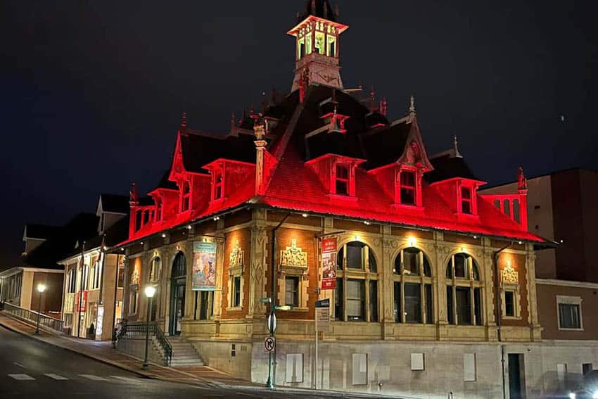 The Customs House Museum lit up at night.