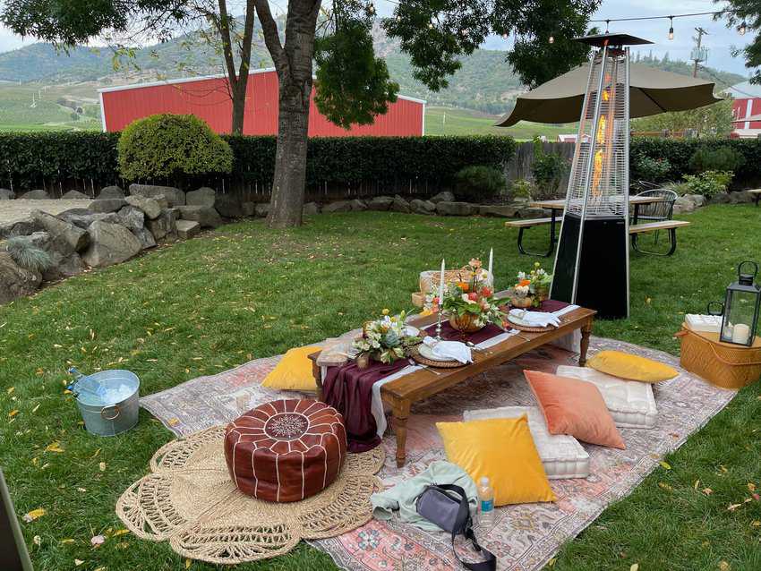 A spread of charcuterie and fruit adorn a low table in the backyard of Del Rio Winery, near Medford.