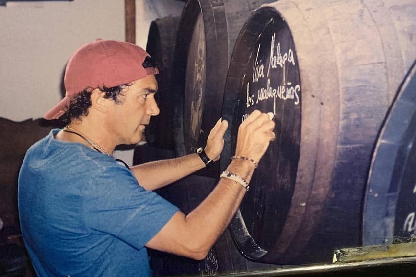 Antonio Banderas signs a wine barrel in the El Pimpi restaurant he co-owns in a photo displayed in the restaurant.