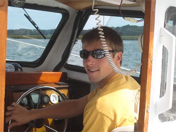 The author piloting the boat on the Darien River